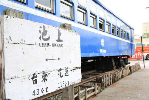 a blue train is sitting on the tracks at Miyama Bed and Breakfasts in Chishang
