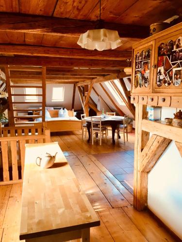 a large room with a table and a dining room at Pension Laura in Chřibská