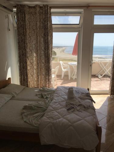 a bedroom with a bed and a view of the ocean at Sand and Sea Apartments in Ulcinj