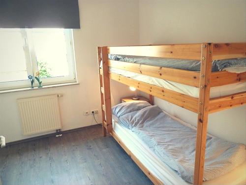 a bunk bed room with two bunk beds in it at Ferienwohnung Strandhafer - nur 300m vom Meer in Kühlungsborn