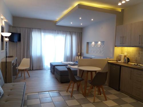 a kitchen and living room with a couch and a table at Irida Studios in Ágios Dimítrios