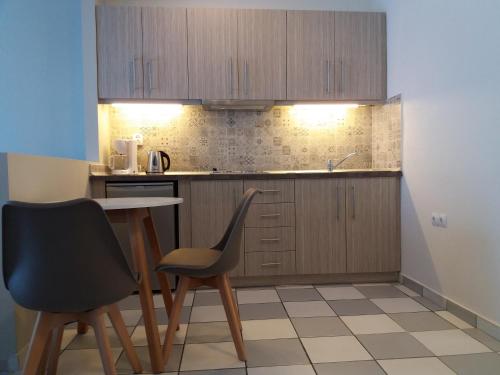 a kitchen with a table and two chairs at Irida Studios in Ágios Dimítrios