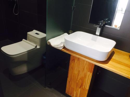 a bathroom with a white sink and a toilet at Fengma Feiyang Hostel in Lhasa