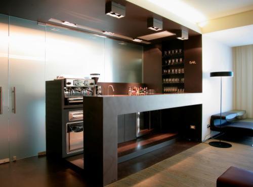 a kitchen with a counter with an oven in it at Art Hotel Udine in Udine