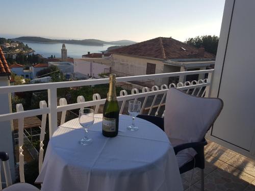 a bottle of wine sitting on a table with two glasses at Tanya-Apartments and Rooms in Hvar