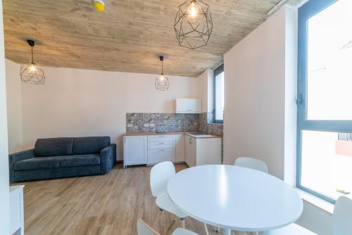 a living room with a white table and a couch at Chapter 5 Hotel in Taʼ Xbiex