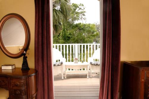 an open door to a patio with a table and chairs at Victorian Luxury One Bedroom Apartment in St. Augustine