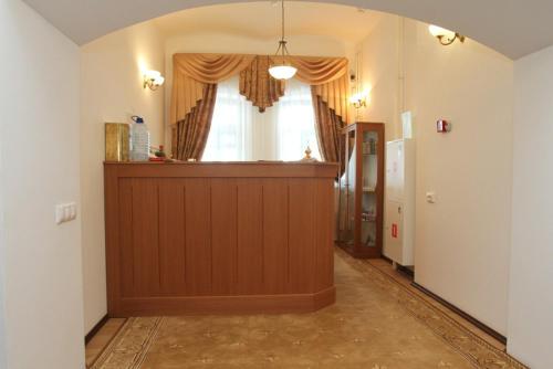 a room with a wooden floor and a large window at Hotel Vostochnaya in Istra