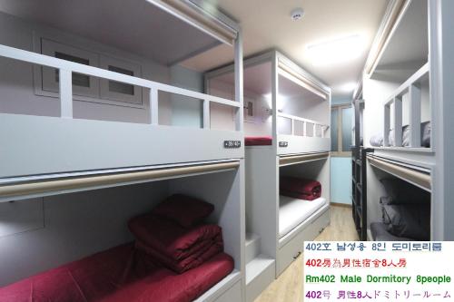a room with two bunk beds with red cushions at Daegu Midtown Hostel in Daegu