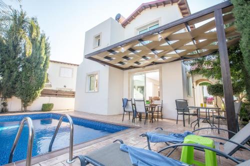 a villa with a swimming pool and a house at Katerina Luxury Villas in Protaras
