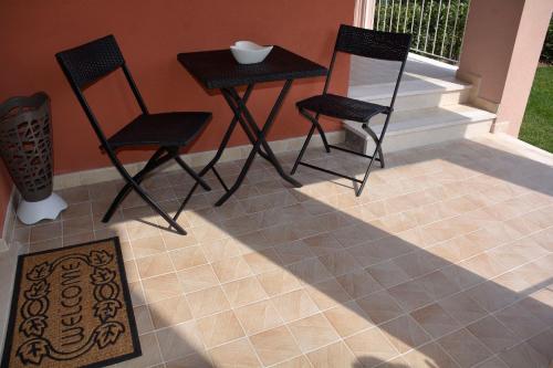 two chairs and a table on a porch at Dream Apartment in Toscolano Maderno