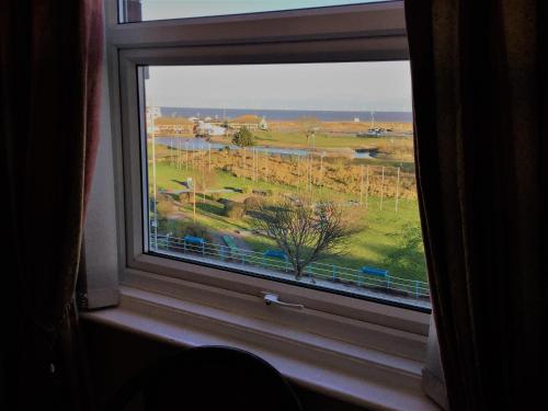 a window with a view of a field through it at Balmoral in Skegness