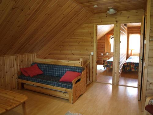 a log cabin with a bench in the attic at Loma-Rantala Cottages in Tahkovuori