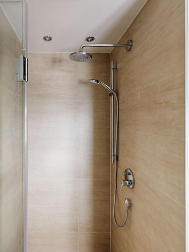a shower with a glass door in a bathroom at Rantum Dorf - Ferienappartments im Reetdachhaus 1& 2 in Rantum