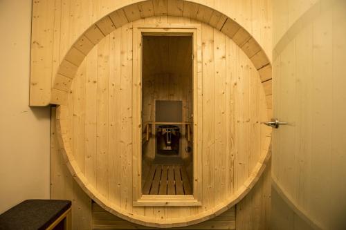 a circular wooden room with a door and a television at Vineta Ferienresidenz Usedom in Koserow