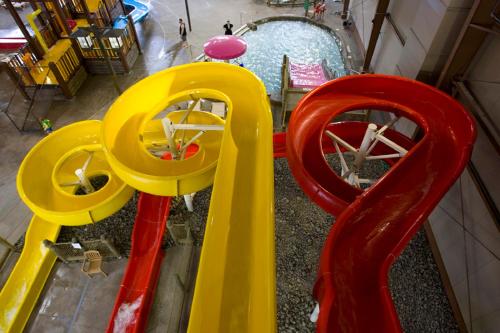 an overhead view of a playground with yellow and red equipment at Hope Lake Lodge & Indoor Waterpark in Cortland