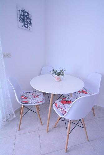 a white table and chairs with a plant on it at Arija in Bilice