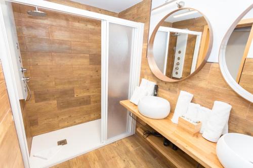 a bathroom with two mirrors and a sink at Palm Friendly Holiday Home in Playa del Ingles