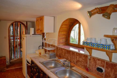 a kitchen with a sink and a refrigerator at Стаи за гости "КАТИ" Guest rooms "KATI" in Balchik