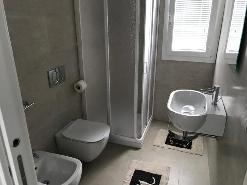 een badkamer met een wastafel, een toilet en een douche bij Casa Gigi in Olbia