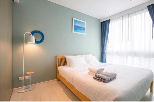 Ένα ή περισσότερα κρεβάτια σε δωμάτιο στο Veranda Residence Pattaya by Boom