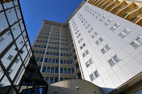 a tall white building with a lot of windows at Hotel Continental in Brno