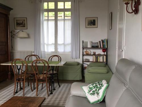 a living room with a table and chairs and a couch at Villa Thérèse in Mers-les-Bains