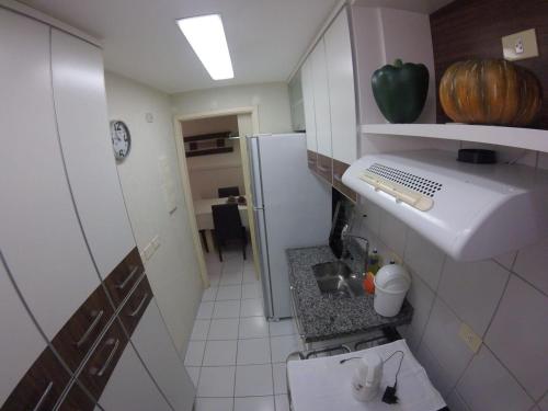 a small kitchen with a sink and a refrigerator at Apartment Neo 2.0 in Maceió