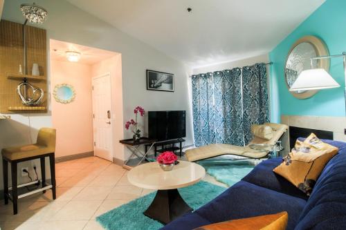 a living room with a blue couch and a table at Strip View luxury Condo in Las Vegas
