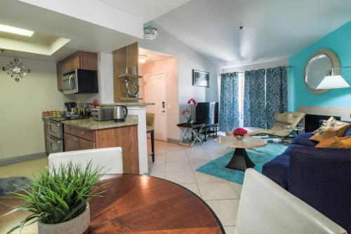 a kitchen and a living room with a couch and a table at Strip View luxury Condo in Las Vegas