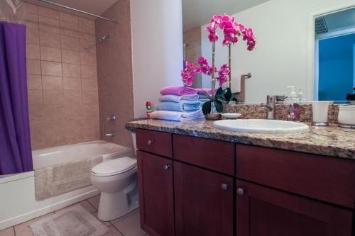 a bathroom with a sink and a toilet and a tub at Strip View luxury Condo in Las Vegas