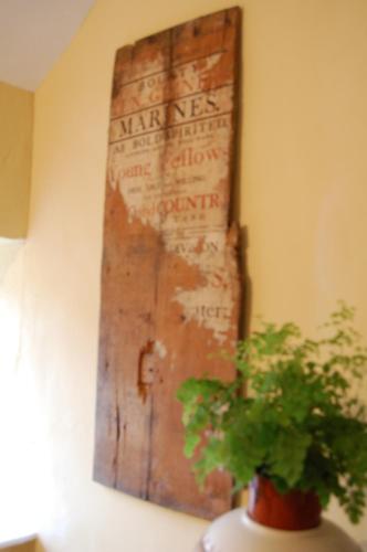 a plant in a vase next to a wooden door at The Three Tuns in Chepstow