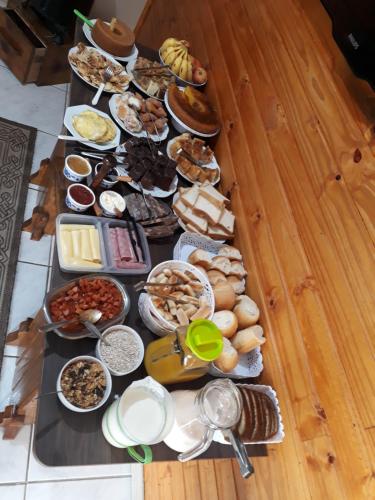 een tafel met een heleboel verschillende soorten voedsel bij Pousada Vó Julia in Urubici