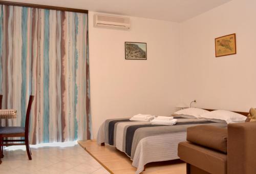 Кровать или кровати в номере Apartments Lorenco