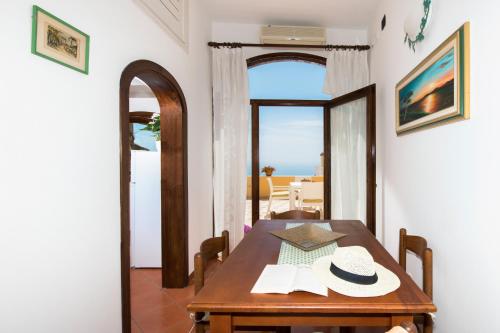 a dining room with a table and a view of the ocean at Casa Chiesa Nuova in Positano