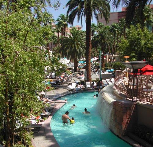 a group of people in a swimming pool at a resort at True 1BR Balcony Suite with Strip View at MGM Signature in Las Vegas