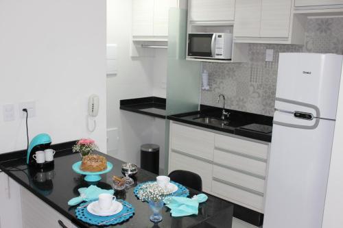a kitchen with a table with food on it at O local para o seu lazer in Santos