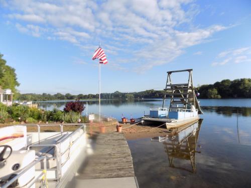 a dock with a boat and an american flag at StoneWall House in Lake Elmo