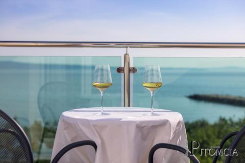 two glasses of white wine sitting on a table at Villa Pitomcia in Podstrana