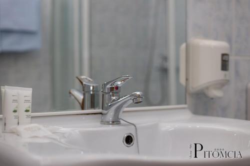 a bathroom sink with a faucet and a mirror at Villa Pitomcia in Podstrana