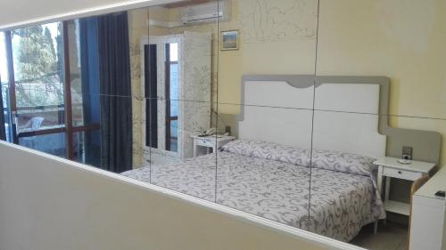 Ένα ή περισσότερα κρεβάτια σε δωμάτιο στο Hotel Laura Christina
