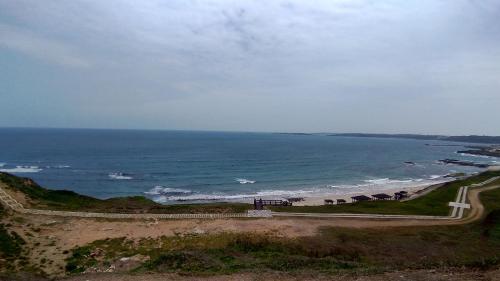 a view of a beach with a road and the ocean at Jama Bay in Xiyu