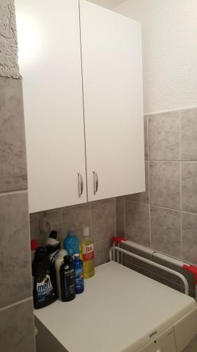 a white cabinet in the corner of a kitchen at Apartman Košuta 2 in Tjentište