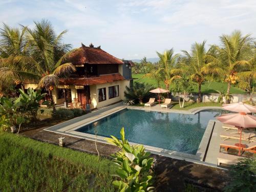 a villa with a swimming pool and a house at Atres Villa in Munduk