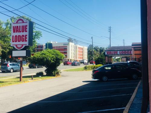a car parked on a street with a value house sign at Value Lodge - Gainesville in Gainesville
