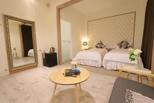 a hotel room with a bed and a mirror at Flora Inn in Tainan