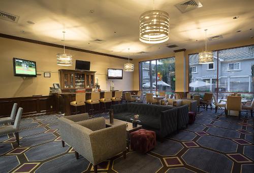 una sala de espera con sillas y un bar en Grand Hotel, en Sunnyvale