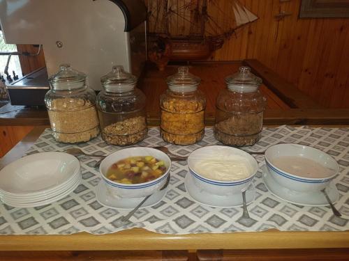 a table with jars of food and bowls of nuts at The Spotted Grunter Resort in Port St Johns