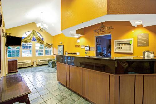 a large lobby with a restaurant with yellow walls at Microtel Inn & Suites by Wyndham Gatlinburg in Gatlinburg
