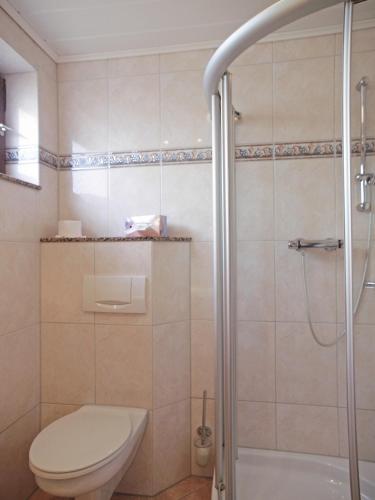 a bathroom with a toilet and a shower at Haus Thorwarth - Hotel garni in Cuxhaven